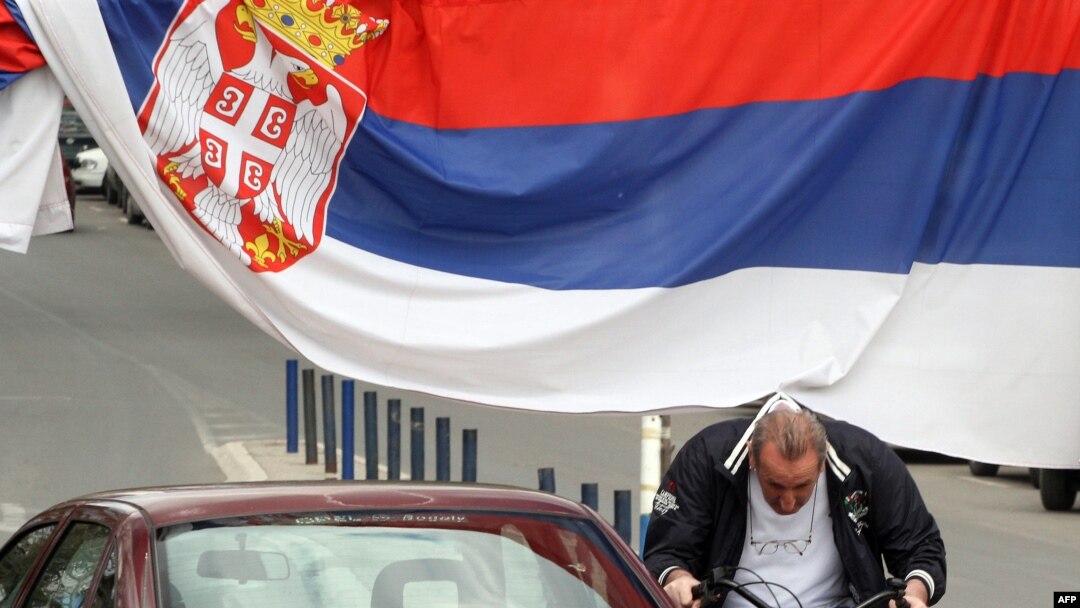 An ethnic Serb rides a bicycle in the ethnically divided city of Mitrovica on April 20.