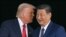 US President Donald Trump (L) talks to China's President Xi Jinping as they shake hands after their talks at the Gimhae Air Base, located next to the Gimhae International Airport in Busan on October 30, 2025.