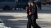 Ukrainian President Volodymyr Zelenskyy (right) and first lady Olena Zelenska hold candles during a ceremony to mark the third anniversary of Russia's all-out invasion of Ukraine, on Independence Square in Kyiv on February 24.