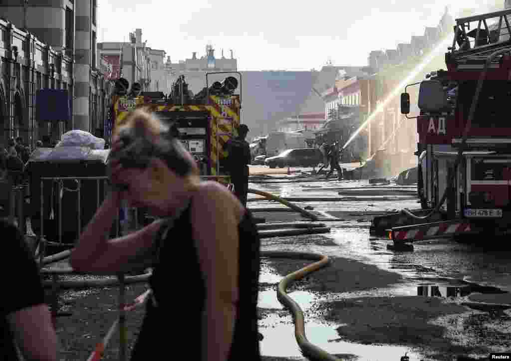 Firefighters work at the site of a Russian drone strike on the Ukrainian port city of Odesa.