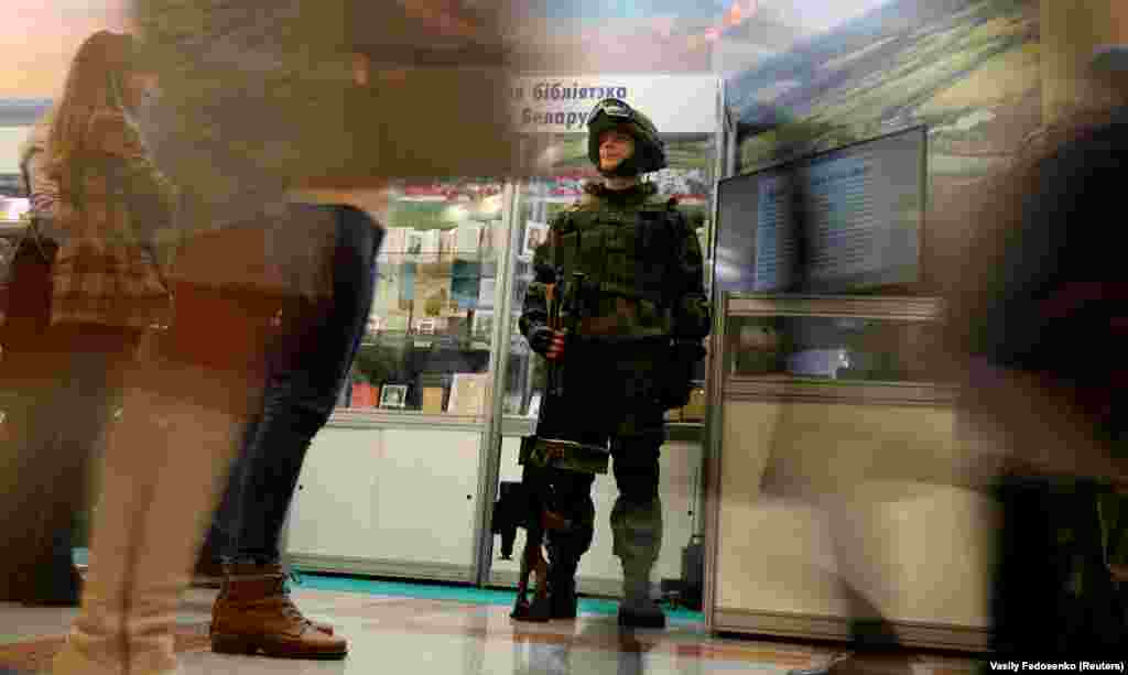 A Belarusian soldier with an automatic rifle stands at an exposition during the XXVII Minsk International Book Fair in Minsk on February 5. (Reuters/Vasily Fedosenko)