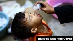 A health worker administers the polio vaccine to a child in Karachi. Pakistan and Afghanistan are the only two remaining countries in the world where polio is endemic. (file photo)