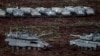 Israeli tanks and armored personnel carriers prepare near the Lebanese border.
