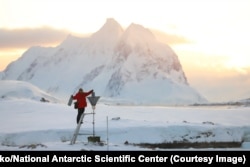 A Ukrainian meteorologist checks a snow gauge at the Vernadsky base.