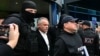 Moldovan oligarch Vladimir Plahotniuc (center) exits Chisinau International Airport under police escort on September 25 after his extradition from Greece. 