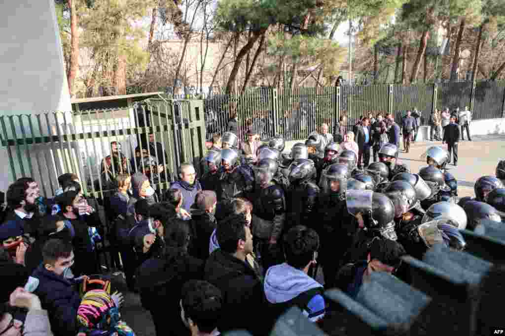 Iranian students scuffle with police at the University of Tehran during a demonstration driven by anger over economic problems on December 30. (AFP/Stringer)