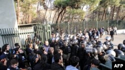 Iranian students scuffle with police at the University of Tehran during a demonstration in the capital Tehran on December 30, 2017. 