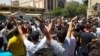 Iranians protest at Tehran's Grand Bazaar on the morning of June 25 after the black-market exchange rate for the rial currency fell by more than 10 percent in a single day. 