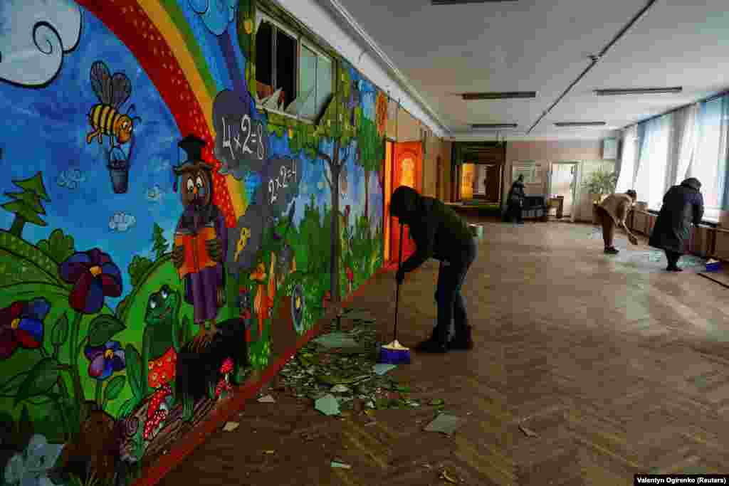 Пошкоджена російським обстрілом школа у Дніпровському районі Києва. Вчителі прибирають уламки скла після атаки