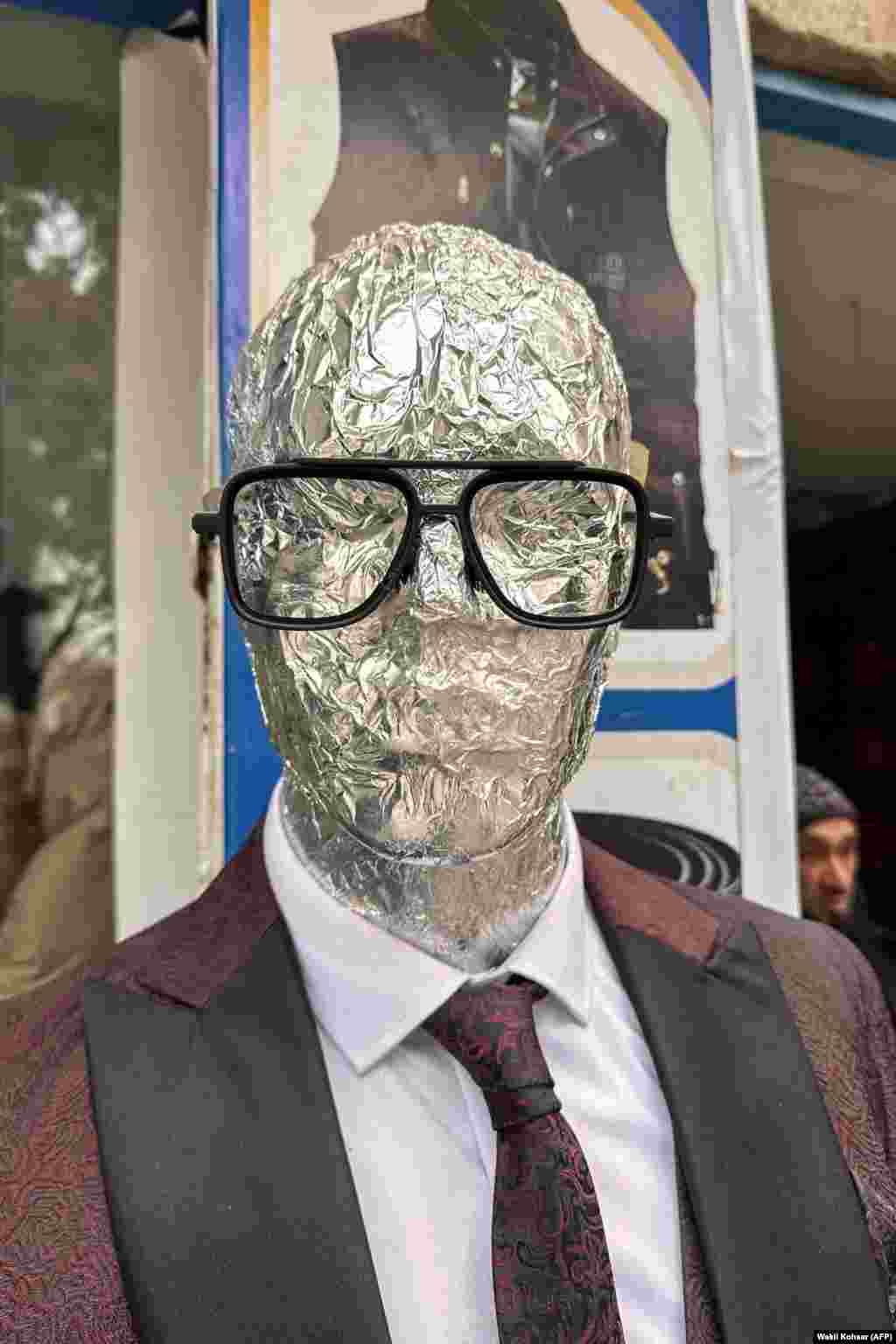 A mannequin wrapped in tinfoil outside a menswear store in Kabul on December 29, 2025.The tour guide, who RFE/RL is not identifying for safety reasons, believes the ban is a result of a fringe interpretation of Islamic rulings coupled with the Taliban’s isolation from Afghanistan’s urban culture through decades of insurgency. "Because they were not in the city, their minds are more conservative," he says.