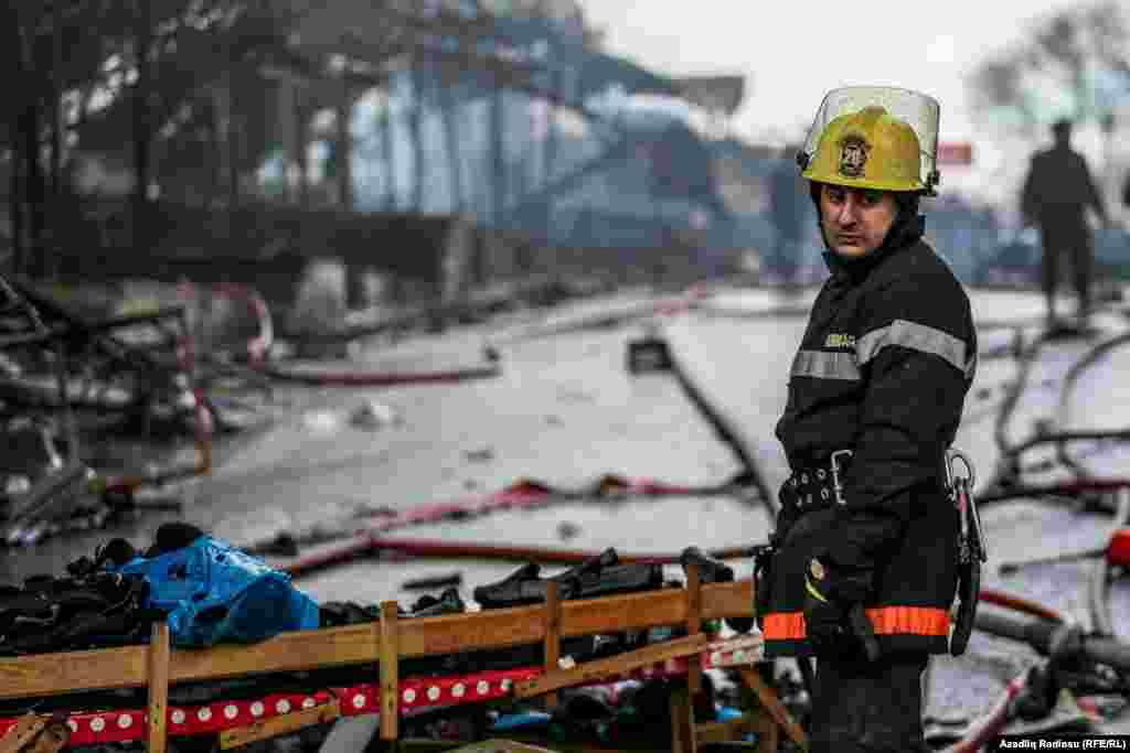 A firefighter helps put out a large fire at the Diglas shopping center in Baku, Azerbaijan, on March 26. (Azadliq Radiosu, RFE/RL)