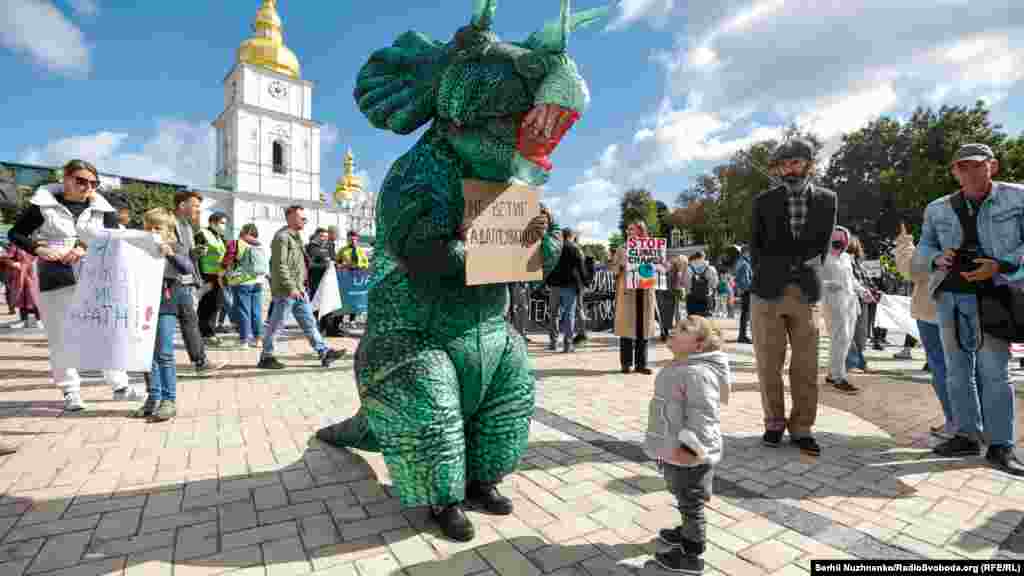 Environmental activists take art in a rally calling for climate action in the center of Kyiv, Ukraine.
