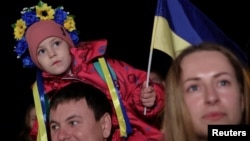 People celebrate on the streets of Kyiv on November 11 after Russia's retreat from Kherson.