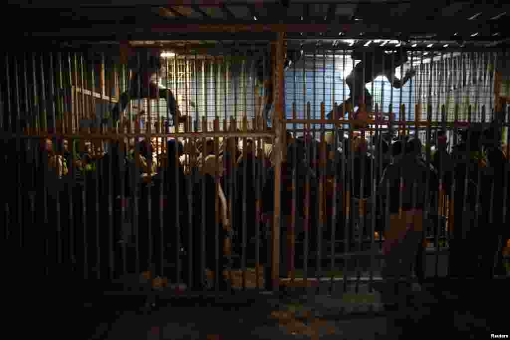 Palestinian laborers wait to cross into Jerusalem at an Israeli checkpoint in the West Bank town of Bethlehem. (Reuters/Ammar Awad)