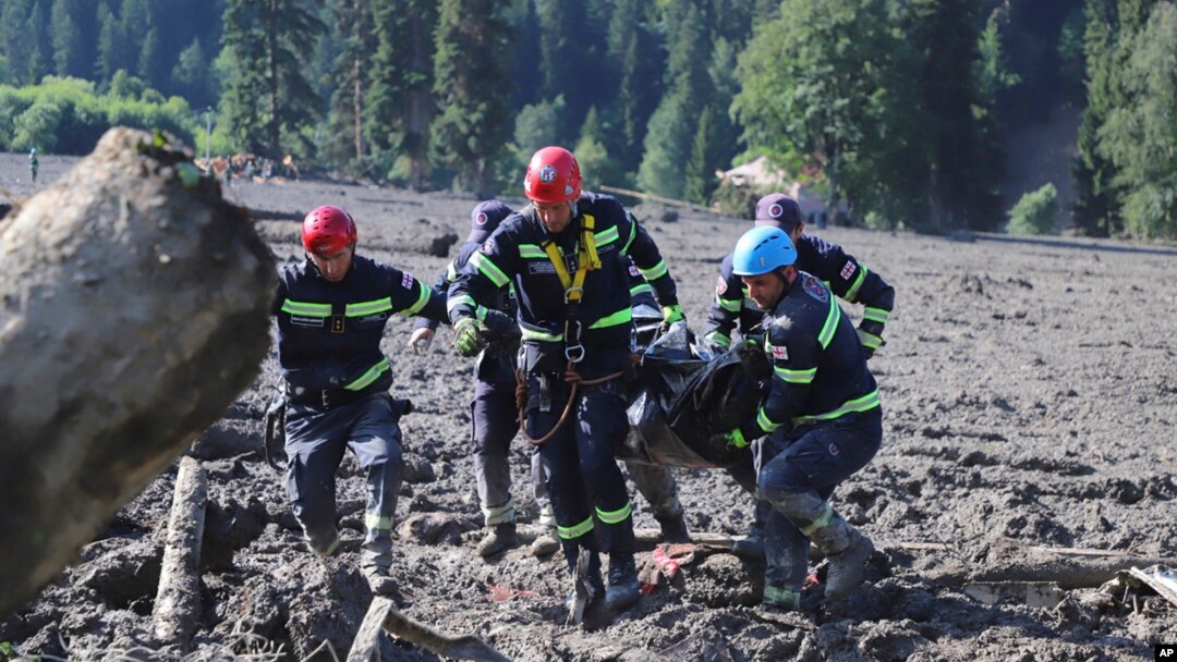 Rescue workers carry the body of a victim of a landslide, near Shovi, about 140 kilometers northwest of Georgia's capital, Tbilisi, on August 4.