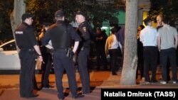 RUSSIA -- Police officers are seen outside an apartment block where a man has taken three hostages after a domestic conflic, in Moscow, May 24, 2018