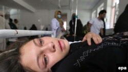 An Afghan school girl receives medical treatment at a local hospital after being admitted for symptoms of poisoning. (illustrative photo from a previous Afghan poisoning incident in May 2017), in Herat, September 3, 2015