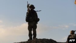 U.S. soldiers patrol near Baraki Barak base in Afghanistan's Logar Province.