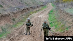 Azerbaijan military sappers clear mines in a countryside outside the town of Fuzuli, November 26, 2020