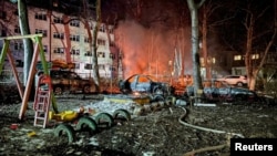 Destroyed cars are seen next to a residential building damaged during a Russian drone strike in Odesa, Ukraine, early on January 17.