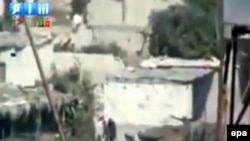 A video grab shows tanks and soldiers advancing in the city of Latakia.