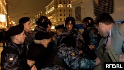 Riot police detain opposition activists at a protest of the Moscow City Duma elections.