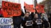 People hold placards during a demonstration in Kemerovo on March 27. The signs say: "How many real victims?"; "Who is really to blame?"; "How much do your closed eyes cost?"; and "Corruption kills."