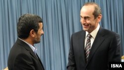 Iran's President Mahmud Ahmadinejad (left) meets with former Armenian President Robert Kocharian in Tehran on January 21.