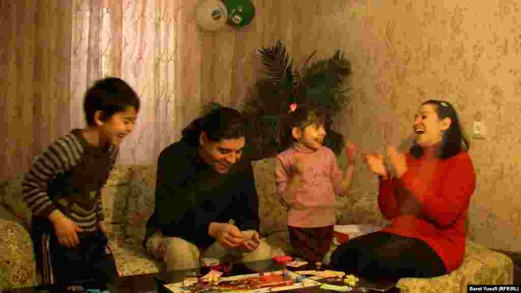 Playing a board game with her family