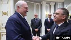 Belarusian President Alyaksandr Lukashenka (left) meeting with Rene Fasel, the head of the International Ice Hockey Federation, in Minsk on January 11
