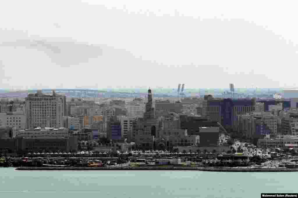 Smoke drifts in the sky over Doha, Qatar after explosions were heard in the city.