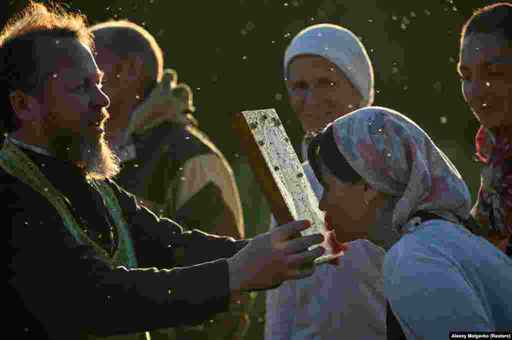 An Orthodox believer kisses an icon.