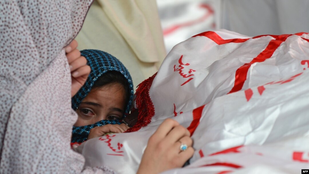 A child reacts as Shi'ite Hazaras gather around the coffin of a bomb victim on the third day of protests following the bombing in Quetta on February 19.