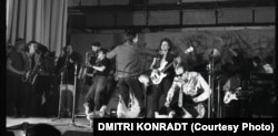 Csirkék özönlik el a Leningrádi Rock Klub színpadát 1987-ben, a Pop-Mehanyika heppeningjén. A performansz művészeti kollektíva szülőatyja Szergej Kurjohin volt, aki avantgárd zeneszerzőként és kísérleti művészként vált híressé. Egy ritka szívbetegségben halt meg, 42 éves korában.