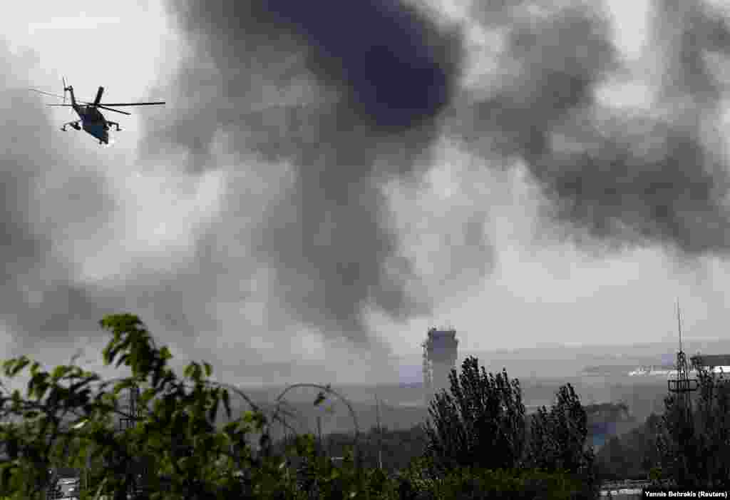 A May 2014 file photo captures a Ukrainian helicopter gunship firing toward the Donetsk airport. Hundreds of fighters died during fighting for the airport, including dozens of Ukrainian servicemen in a single day on January 20, 2015.&nbsp;