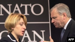 Georgian Foreign Minister Eka Tkeshelashvili (left) tried to put a positive spin on NATO chief Jaap de Hoop Scheffer's news.