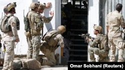 Afghan security forces at the site of an attack on a Shi'ite Muslim mosque in Kabul on August 25