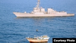 An image released by the U.S. Navy shows the "USS Kidd" near the Iranian-flagged dhow "Al Molai," which reportedly issued distress call claiming a pirate attack.