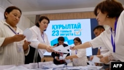 Members of a local electoral commission count ballots at a polling station during parliamentary elections in Almaty, southeastern Kazakhstan, on August 23. 
