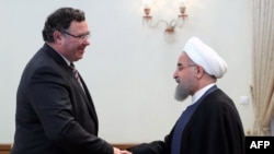 Iranian President Hassan Rohani (R) meets with Patrick Pouyanne Chairman and CEO of French energy company Total, after signing an offshore gas field agreement in Tehran, July 3, 2017