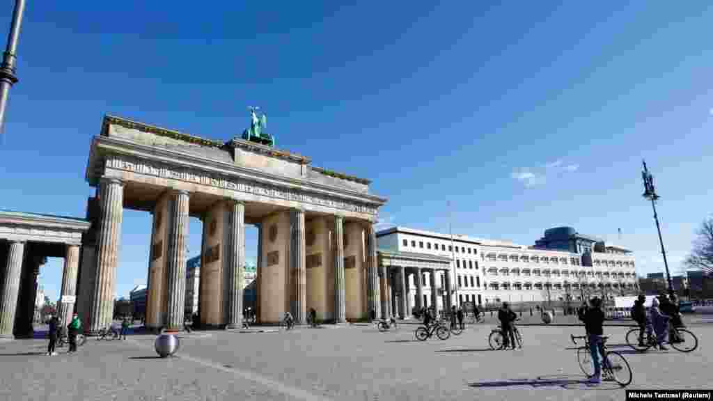 Germany - People stroll at the Pariser Platz in front of the Brandenburg gate in Berlin, 22Mar2020