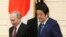 Russian President Vladimir Putin (left) and Japanese Prime Minister Shinzo Abe in Tokyo in December