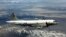 A U.S. Navy EP-3 is shown flying over an unknown location.