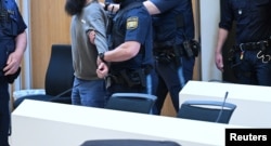 Alleged ringleader Dieter S. is escorted through the courtroom
