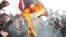 Demonstrators in Tehran burn a U.S. flag on February 22
