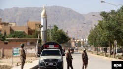 Pakistani security officials inspect the area from where two Chinese nationals were abducted by unknown armed men in Quetta on May 24.