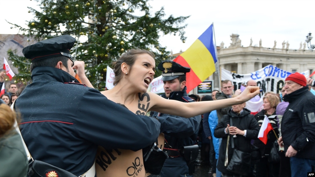 Police try to stop an activist of the Ukrainian feminist group Femen from protesting on St. Peter's Square at the Vatican on January 13.