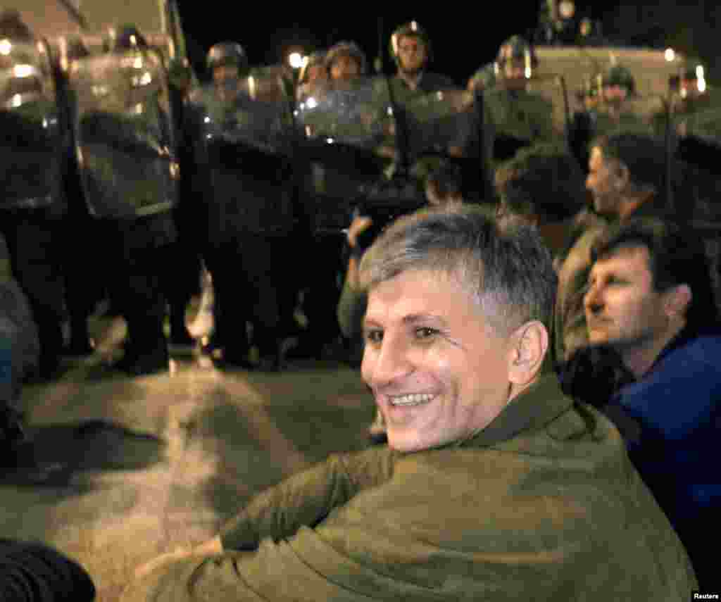 Djindjic and fellow protesters sit in front of a police cordon during a march against Yugoslav President Slobodan Milosevic on September 29, 1999.