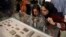 Journalists look at ancient clay tablets that were returned to Iran from the United States at the National Museum in Tehran in 2019.