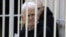 Nobel Peace Prize laureate Ales Byalyatski, who co-founded the Vyasna (Spring) human rights group, sits inside a defendants' cage during a court hearing in Minsk on January 5. 